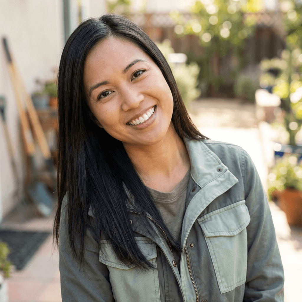 Female hospitality coordinator in her early 30s, Black, friendly professional look at a tidy desk with a notebook